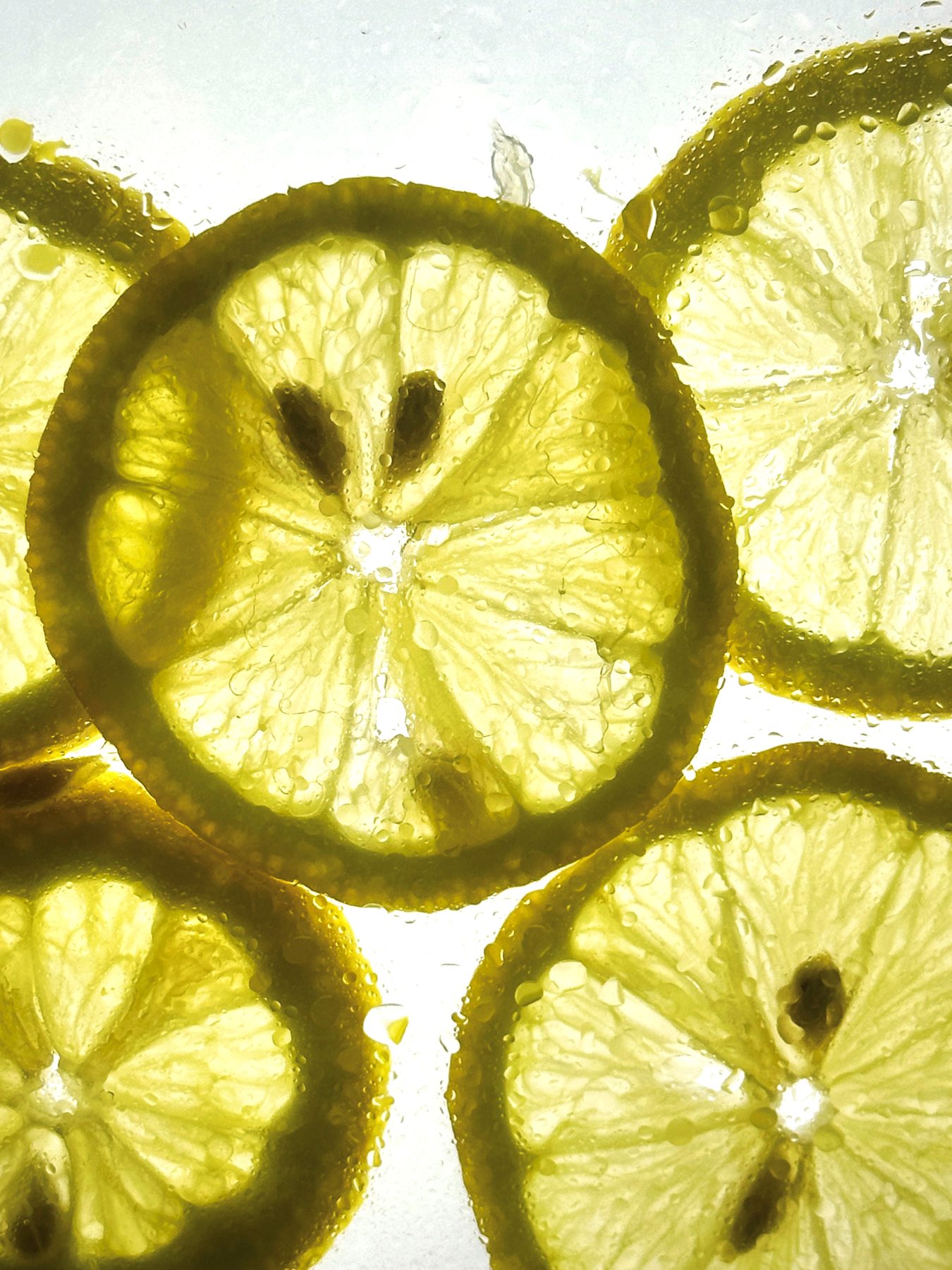 Backlit citrus slices in soda water, macro detail at Dissolved Solids Damansara Kim