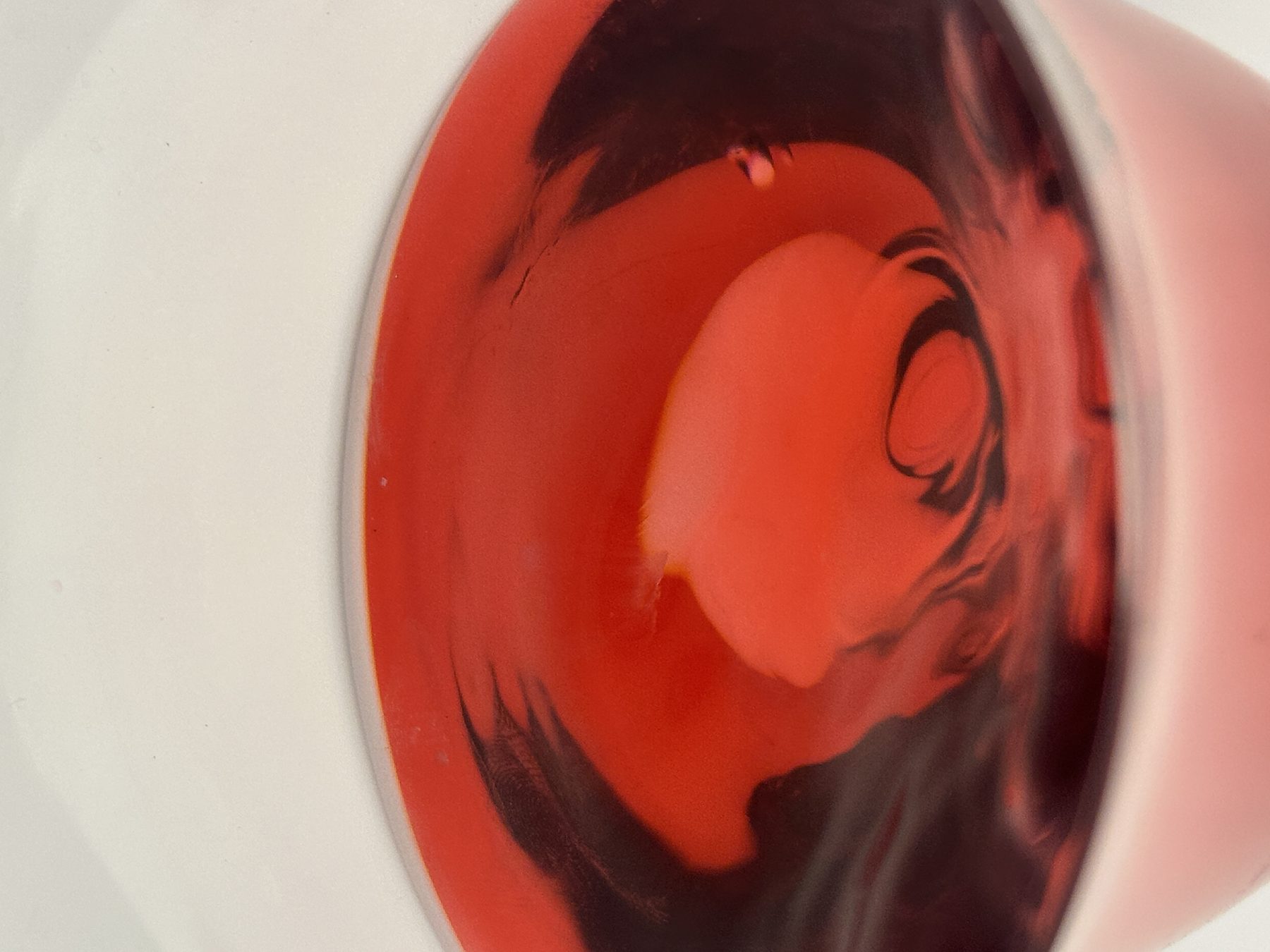 Macro close-up of a deep red cocktail surface with marbled tones at Dissolved Solids