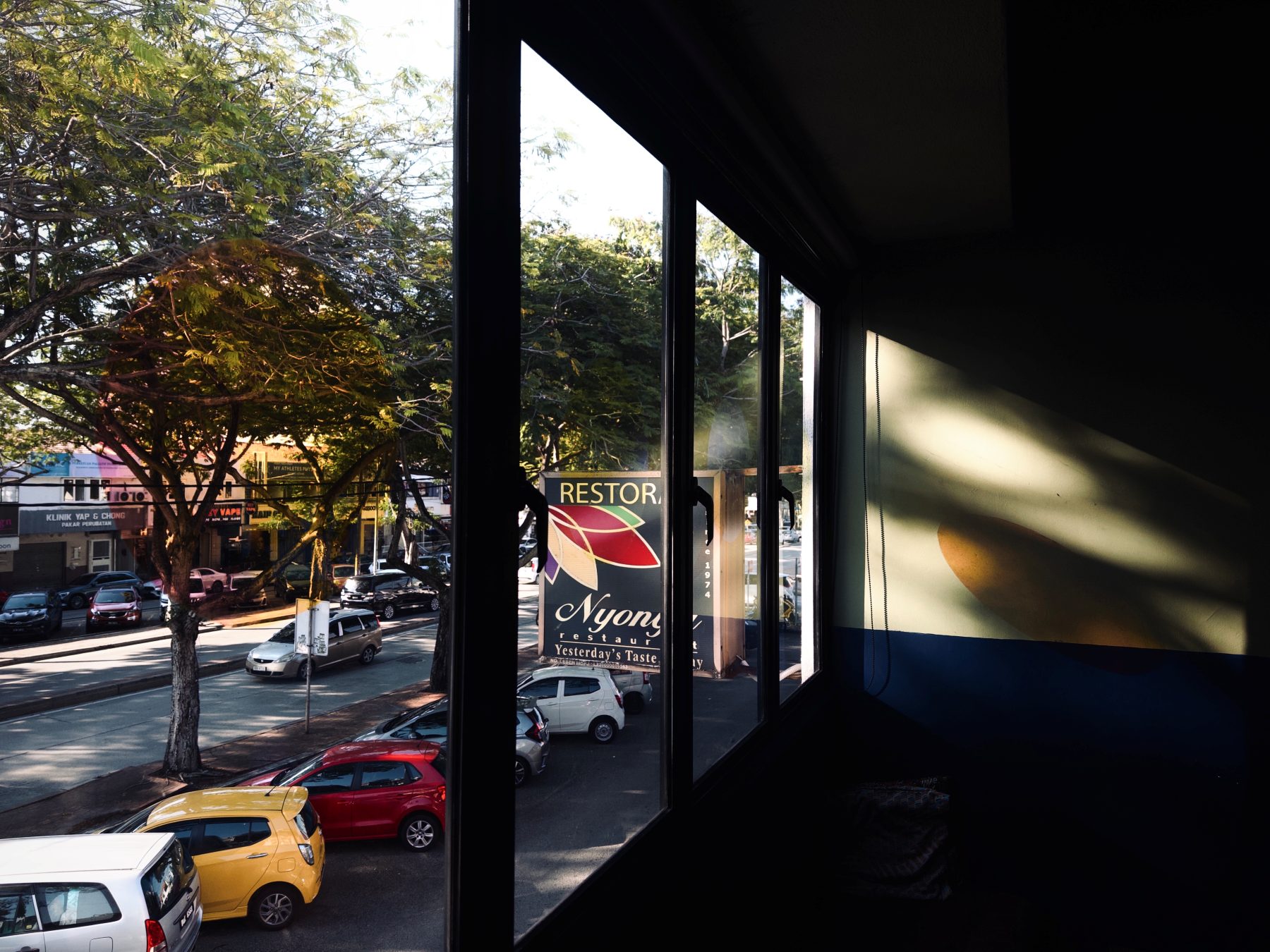 Street-side window view from Soluble Solids onto SS2 Petaling Jaya in afternoon light