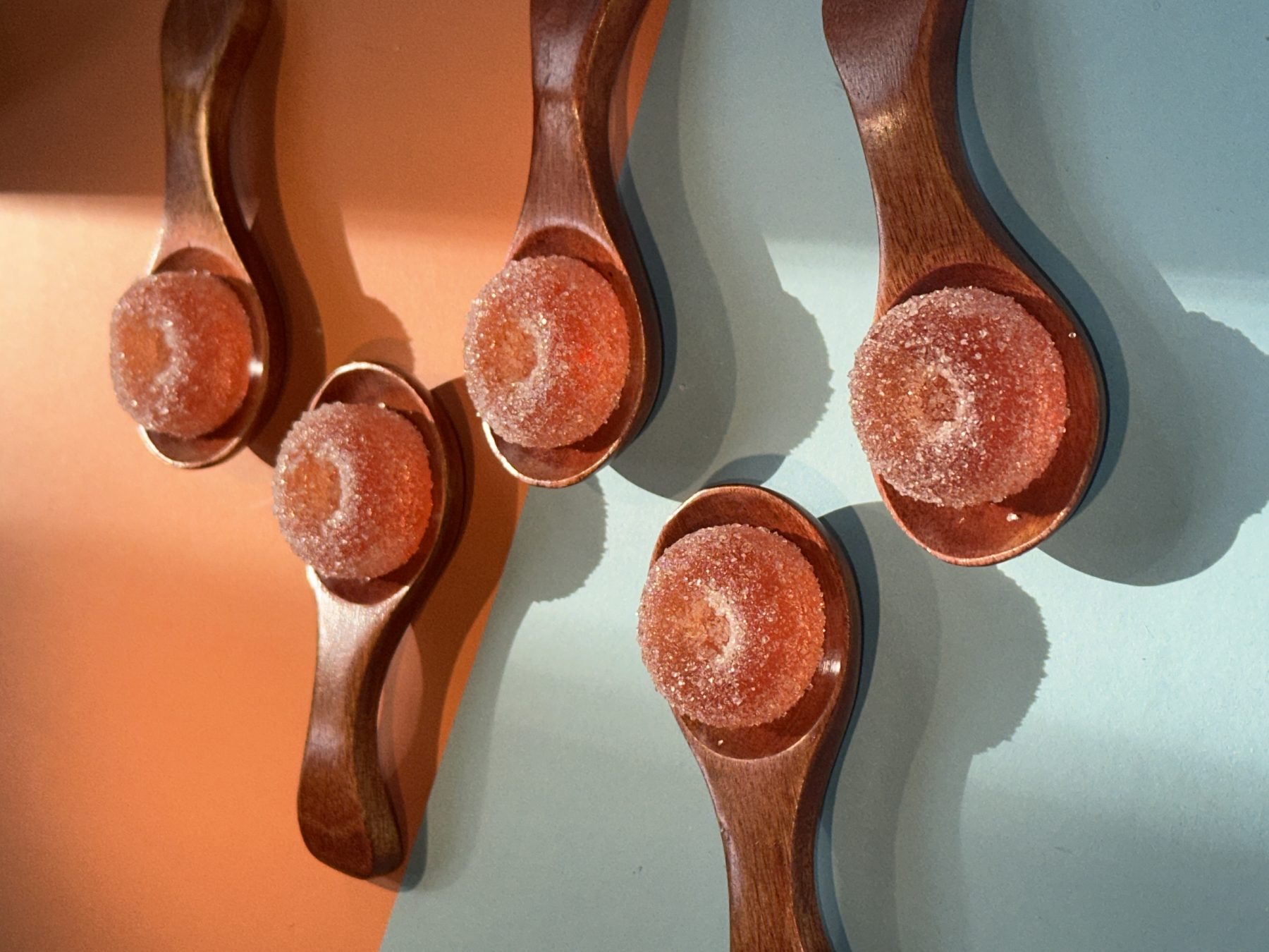 Macro close-up of dried fruit suspended in golden infusion at Soluble Solids